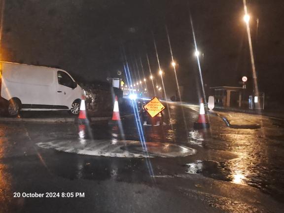 Roadsigns at mini roundabout on flooded prom in Salthill