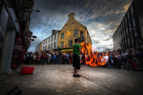 Street performer playing with fire in front of audience