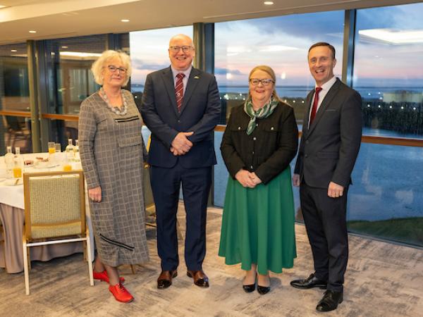 Four Representatives of Galway Chamber, Galway County Council and Galway City Council standing in a hotel room