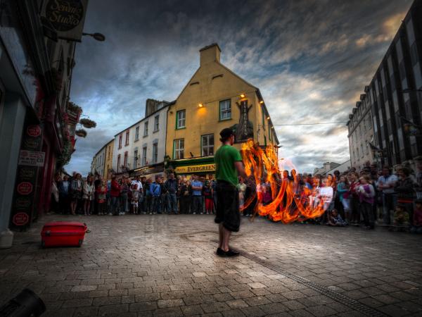 Street performer playing with fire in front of audience